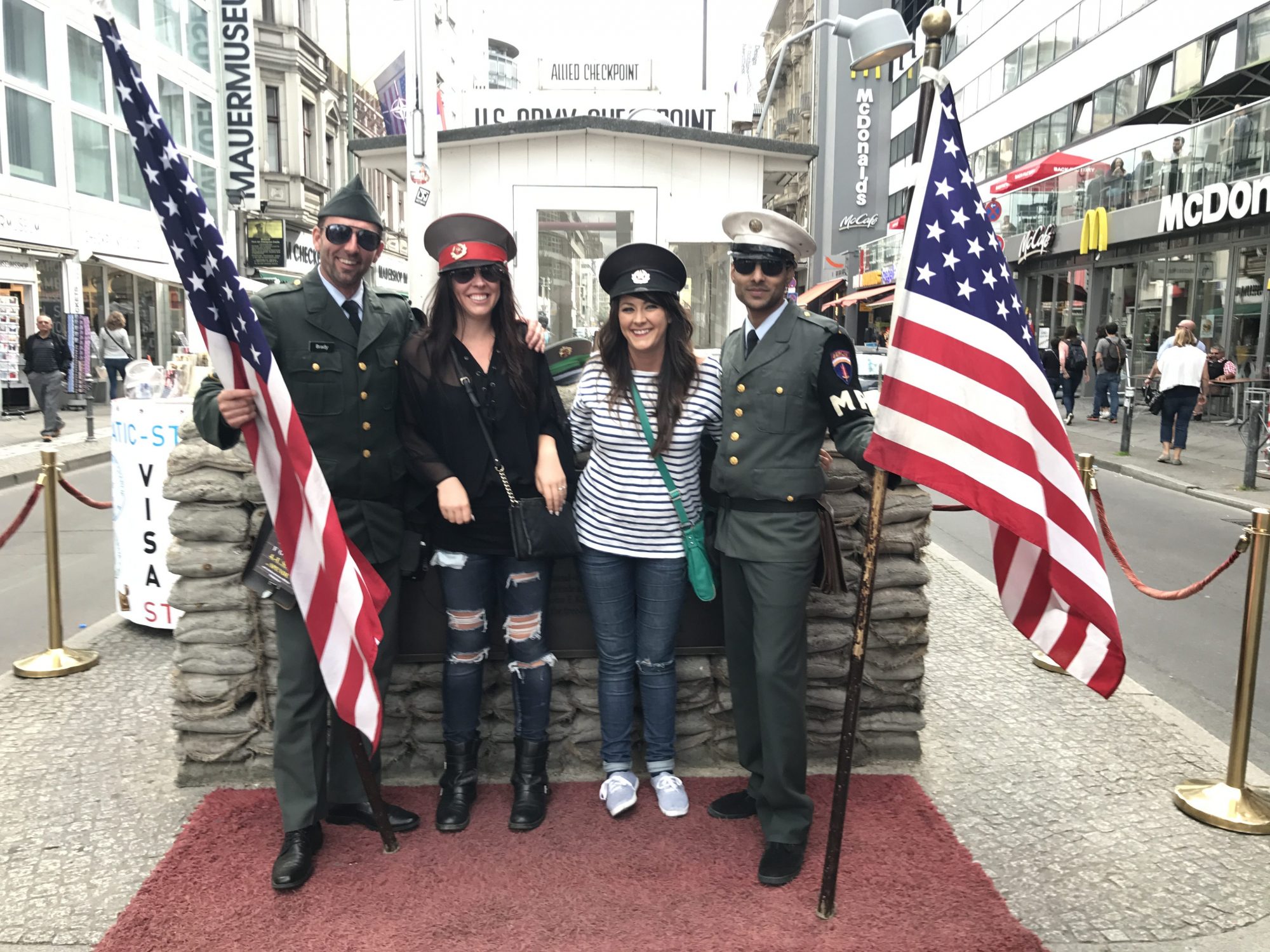 Checkpoint Charlie "guards" with two friends posing for pictures