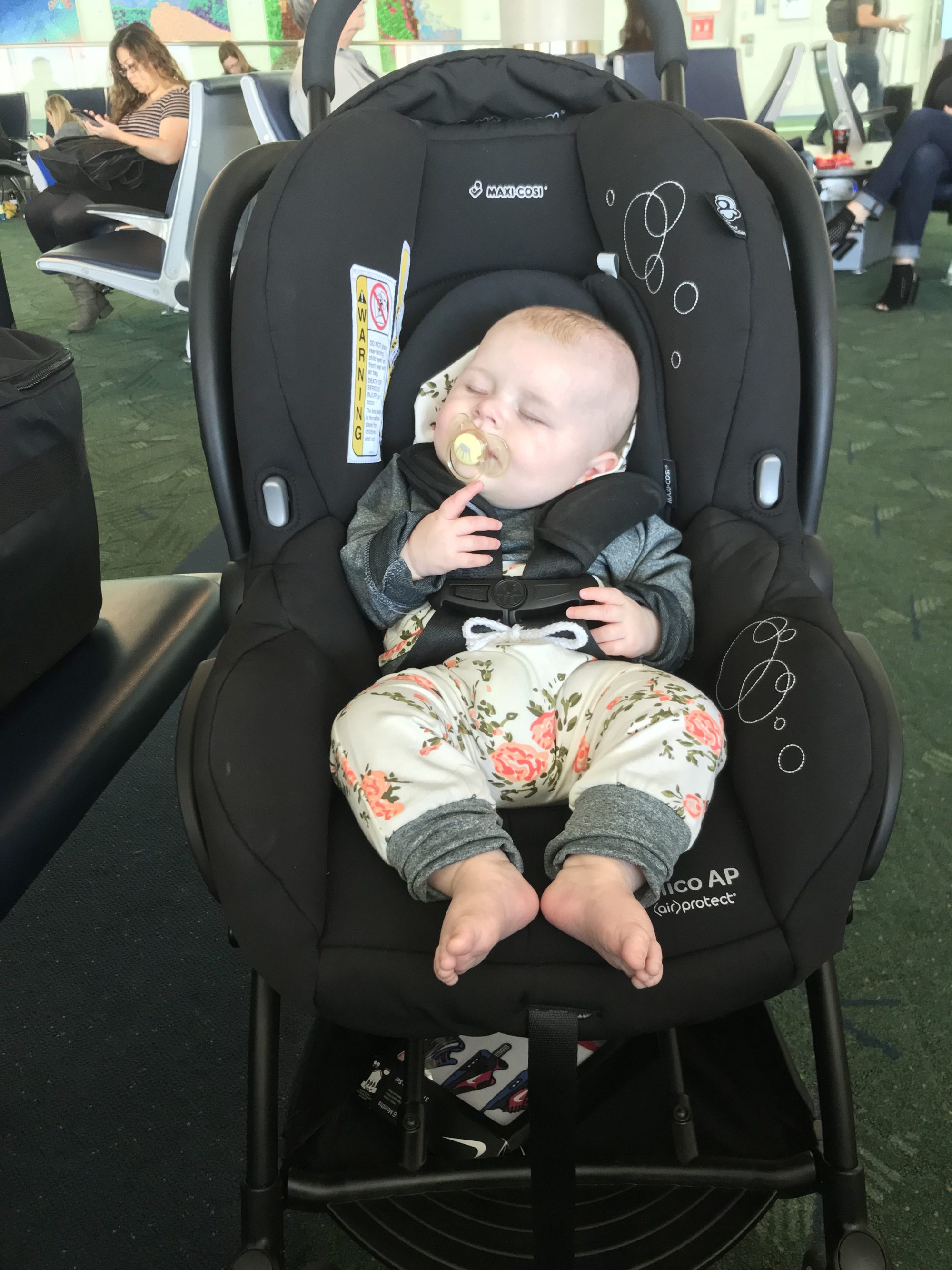 a baby in her stroller in the Portland airport