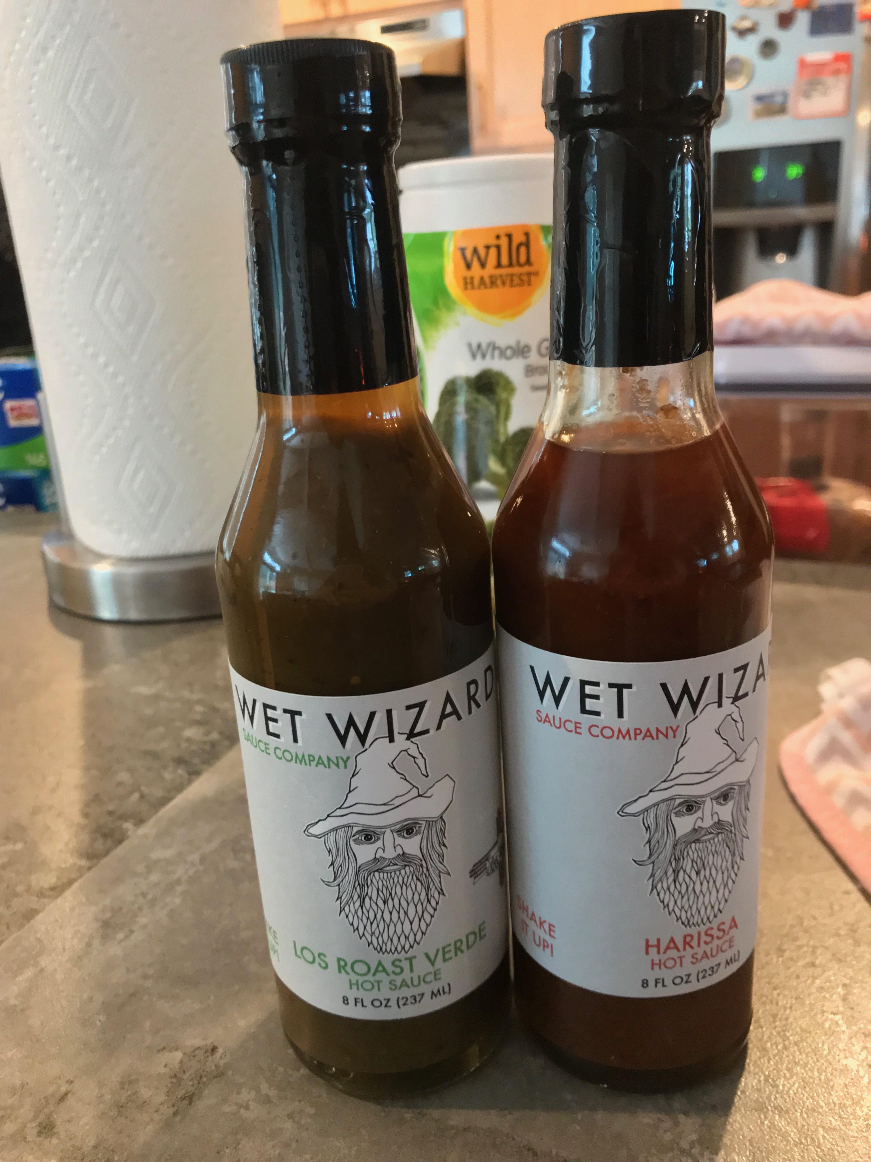 Wet wizard los roast verde and harissa hot sauce bottles
